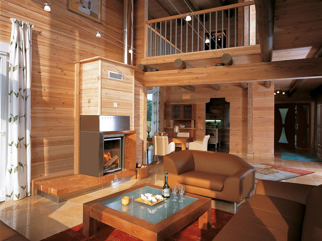 Salon avec murs en bois type chalet et cheminée maisons elk